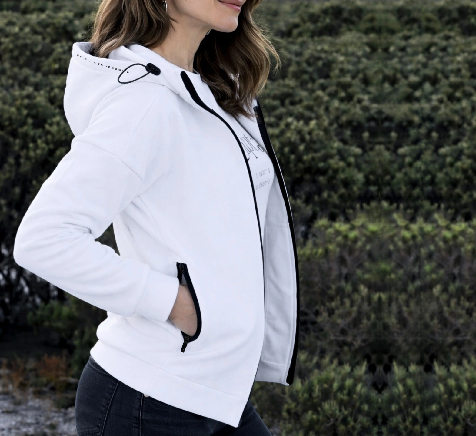 oi captain female model wearing seascape hoodie full zip white side close up view outdoors.jpg