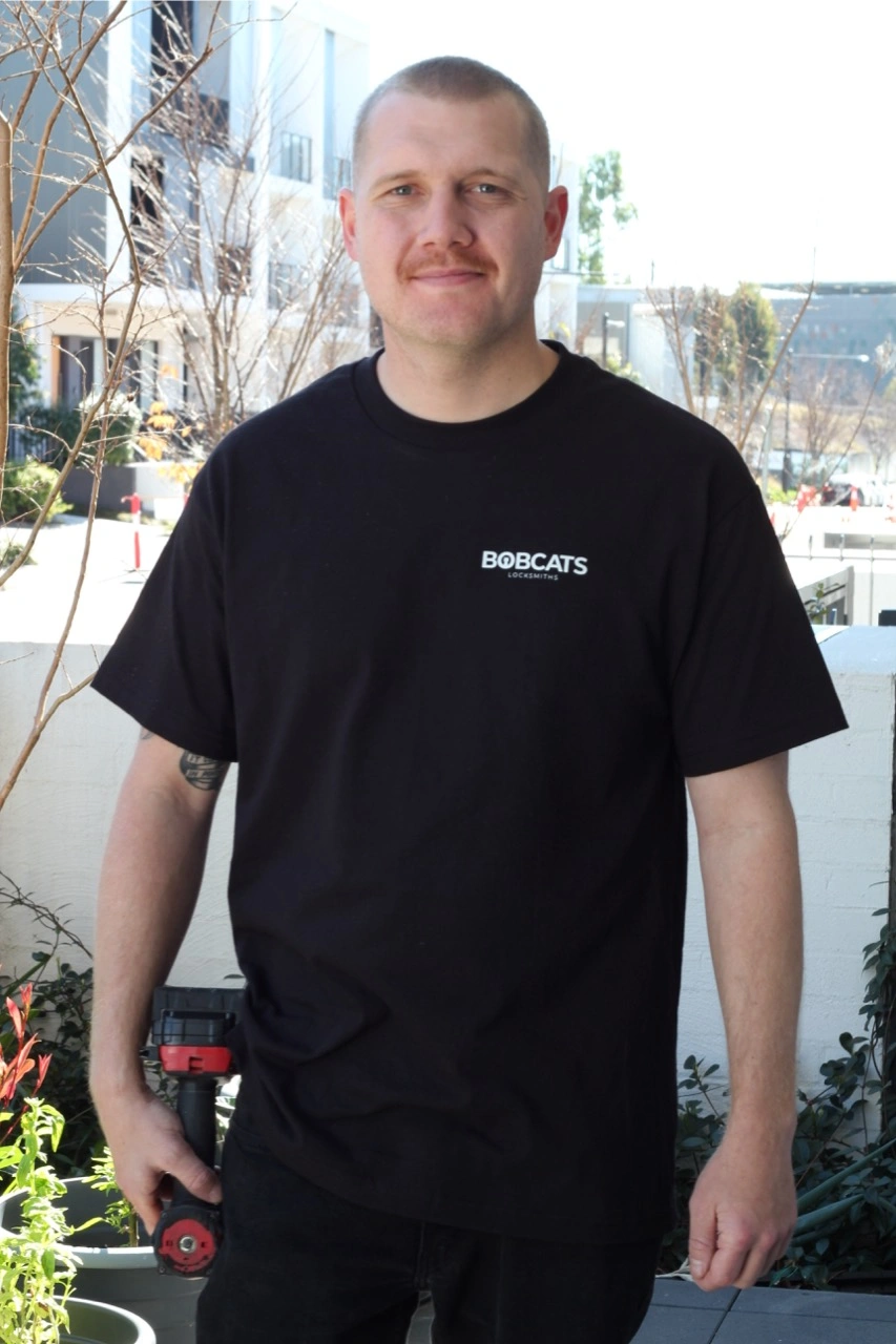 Stuart wearing bobcats locksmiths shirt