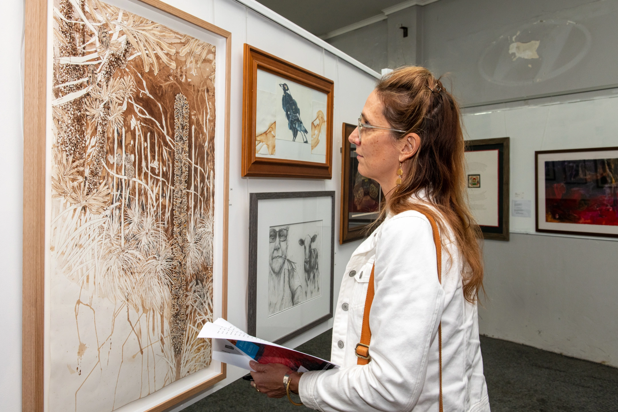 Toni Schuch - looking at one of the artworks.jpg