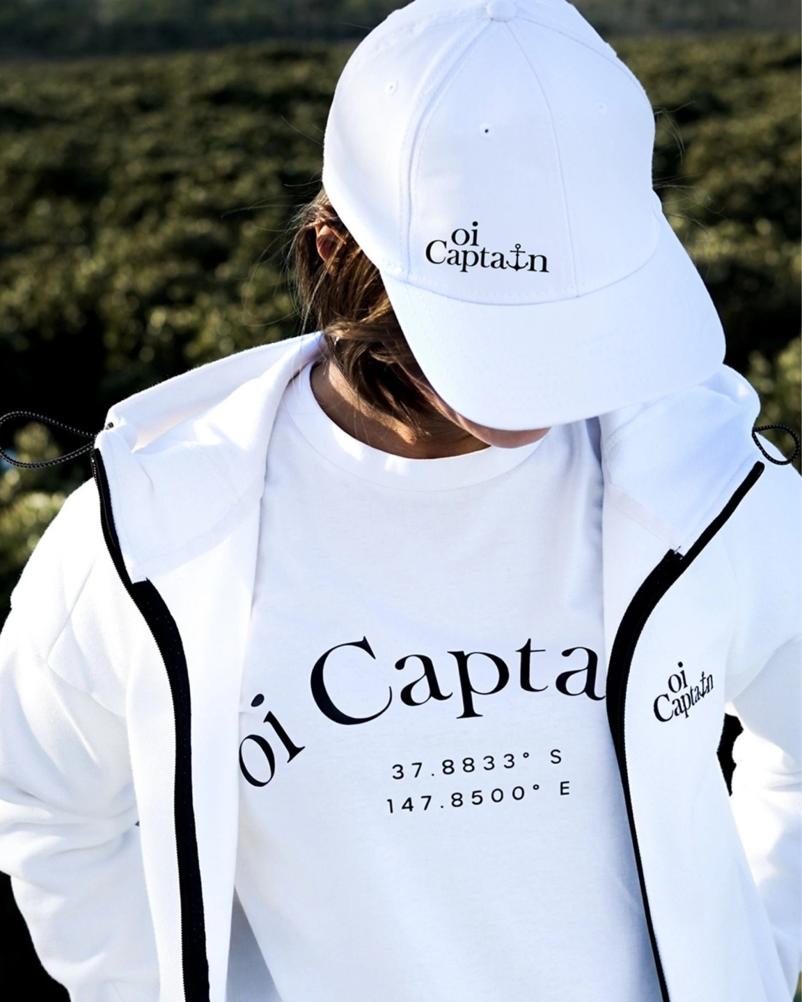 Female model wearing Oi Captain White Seascape Hoodie Jacket, White La Bella Vita T-shirt and White Endless Summer Cap front view.jpg