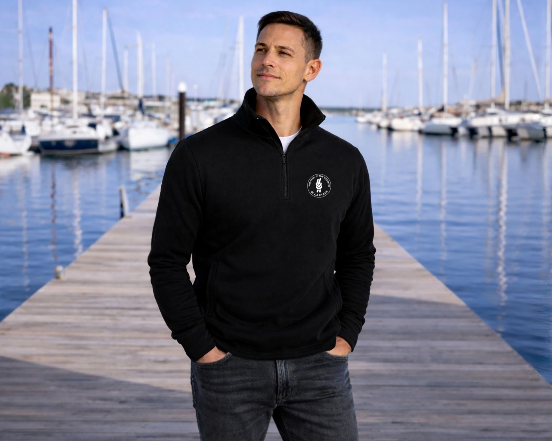 male model wearing oi captain weekend edition half zip sweatshirt black casual pose coastal lifestyle.jpg