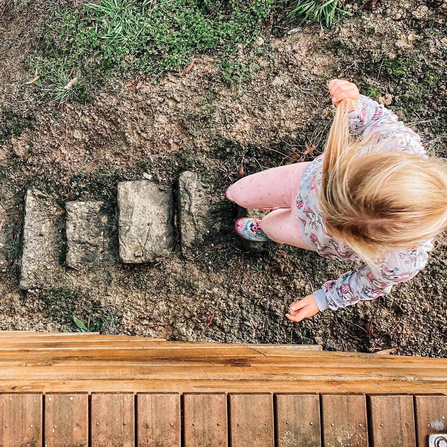 overhead of girl walking down muddy steps.jpg