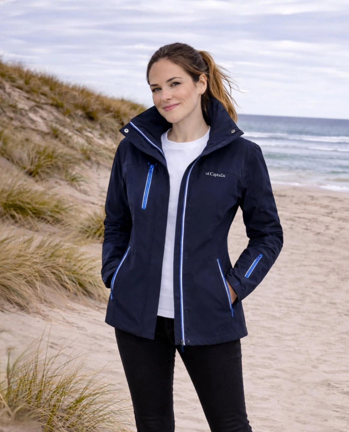 female model wearing Oi Captain Caravela Womens Waterproof Shell Jacket navy front view outdoors.jpg