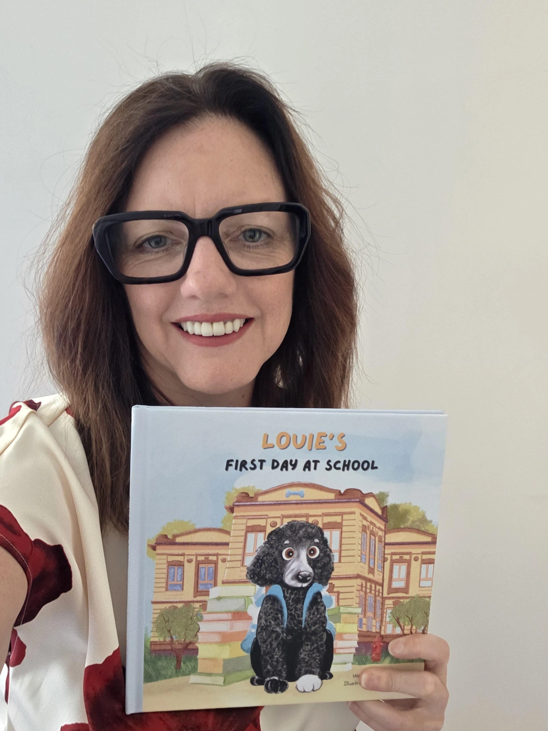 Photo with book red and white blouse.jpg