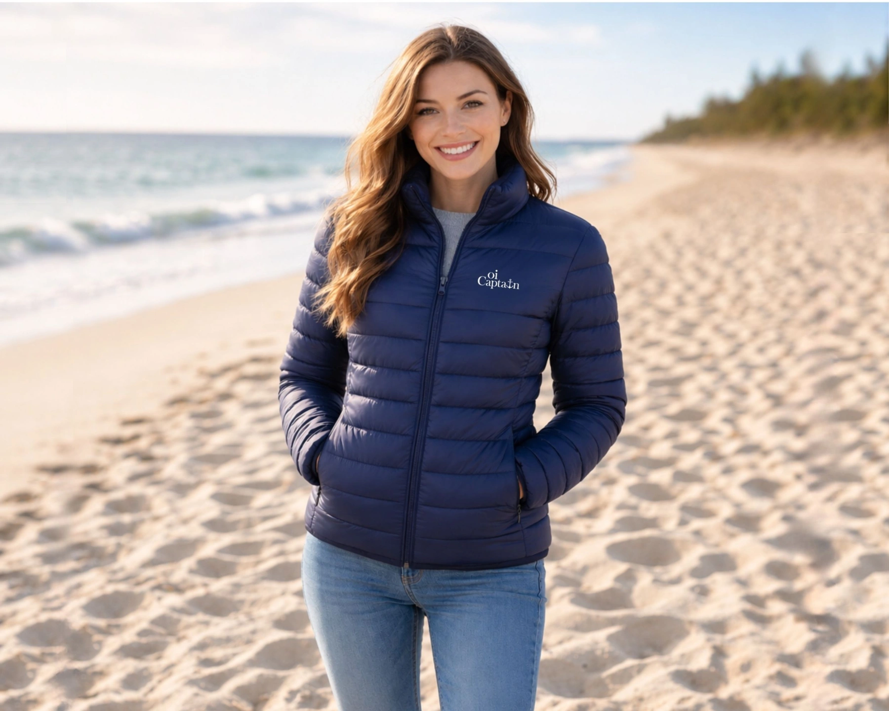 female model wearing oi captain venus puffer jacket navy front view coastal lifestyle.jpg