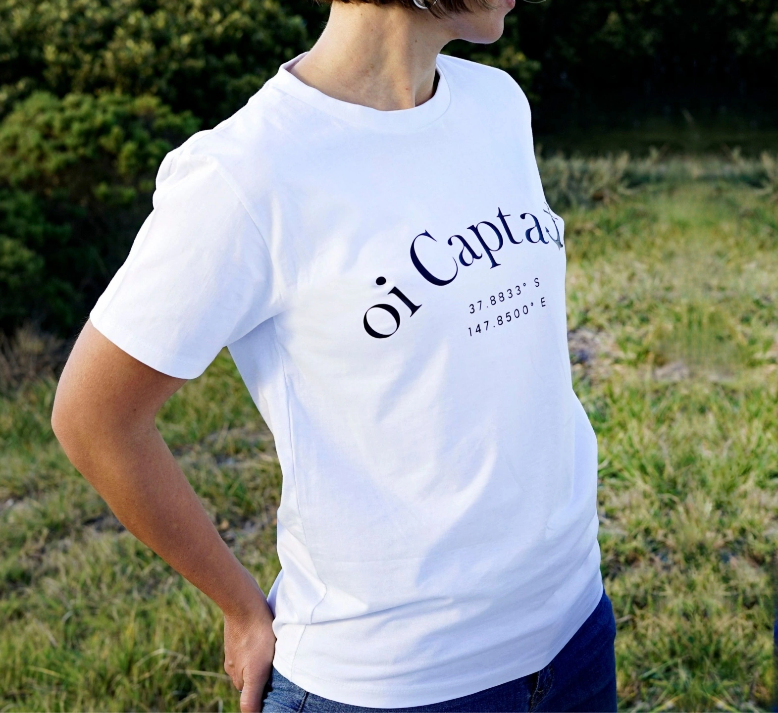 oi captain female model wearing la bella vita t shirt white close up front view outdoors.jpg