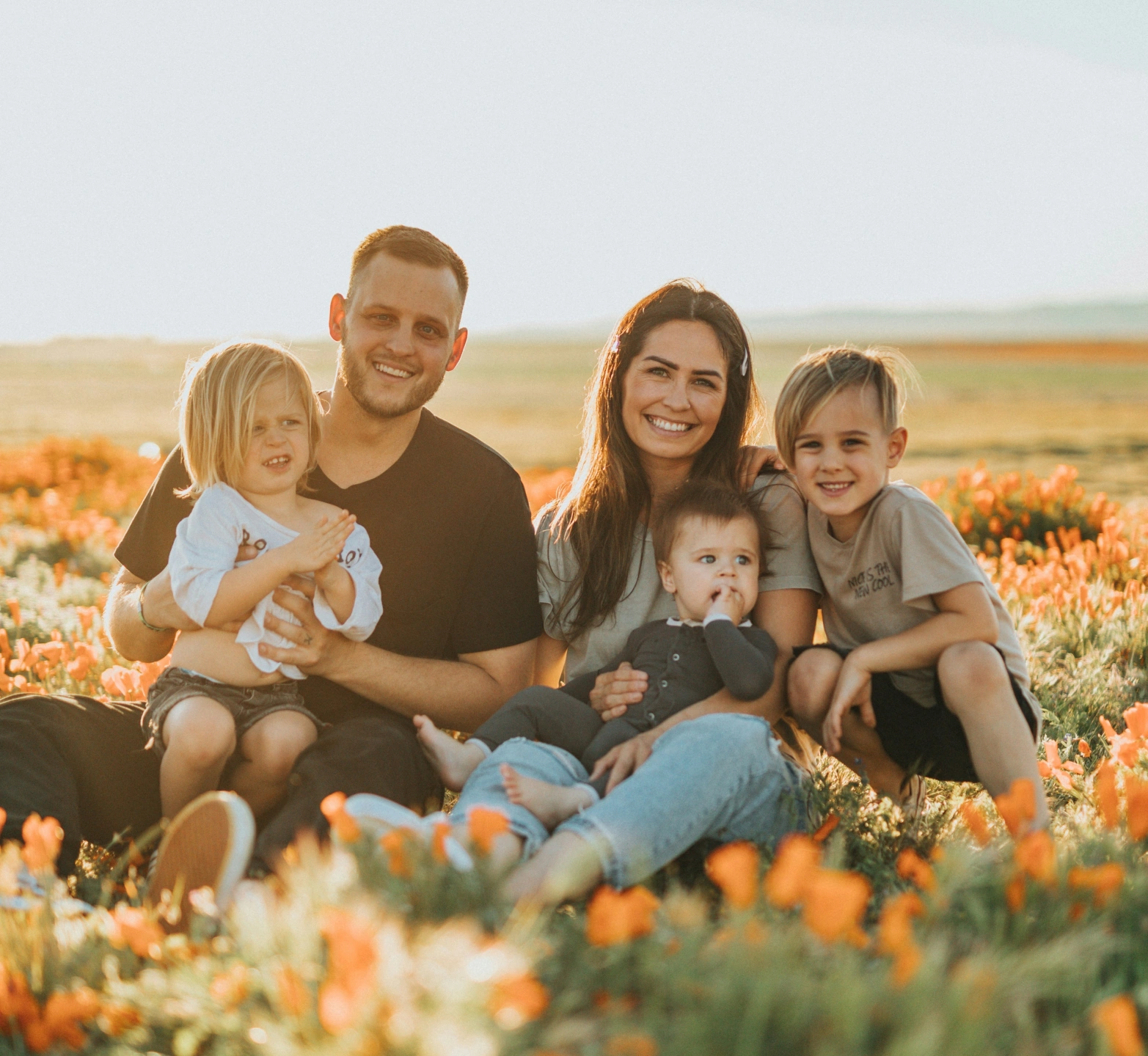 smiling-happy-family-with-kids-in-a-field.jpg