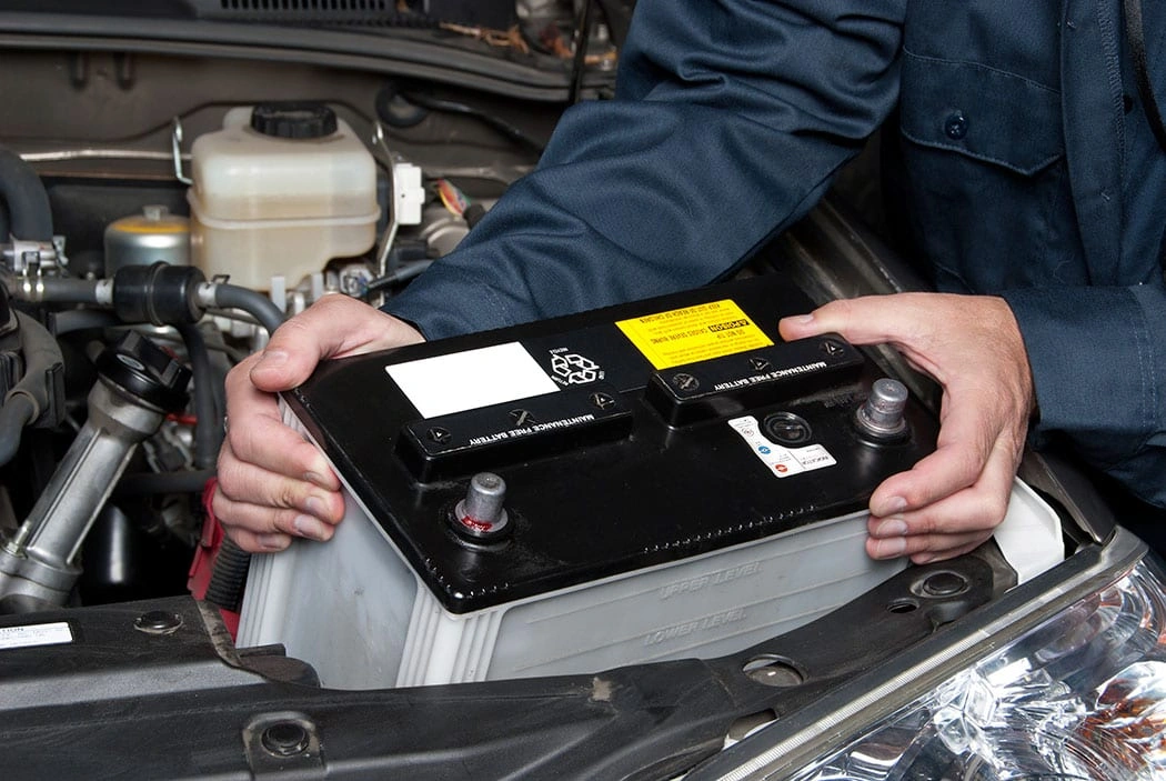 Auto-mechanic-replacing-car-battery.jpg