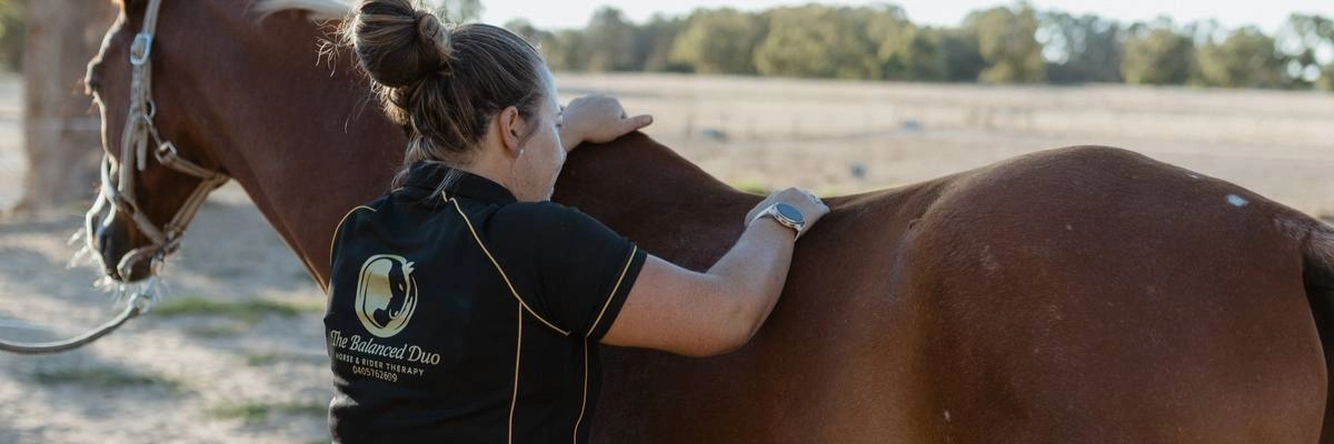Renae doing an equine muscle release treatment.png