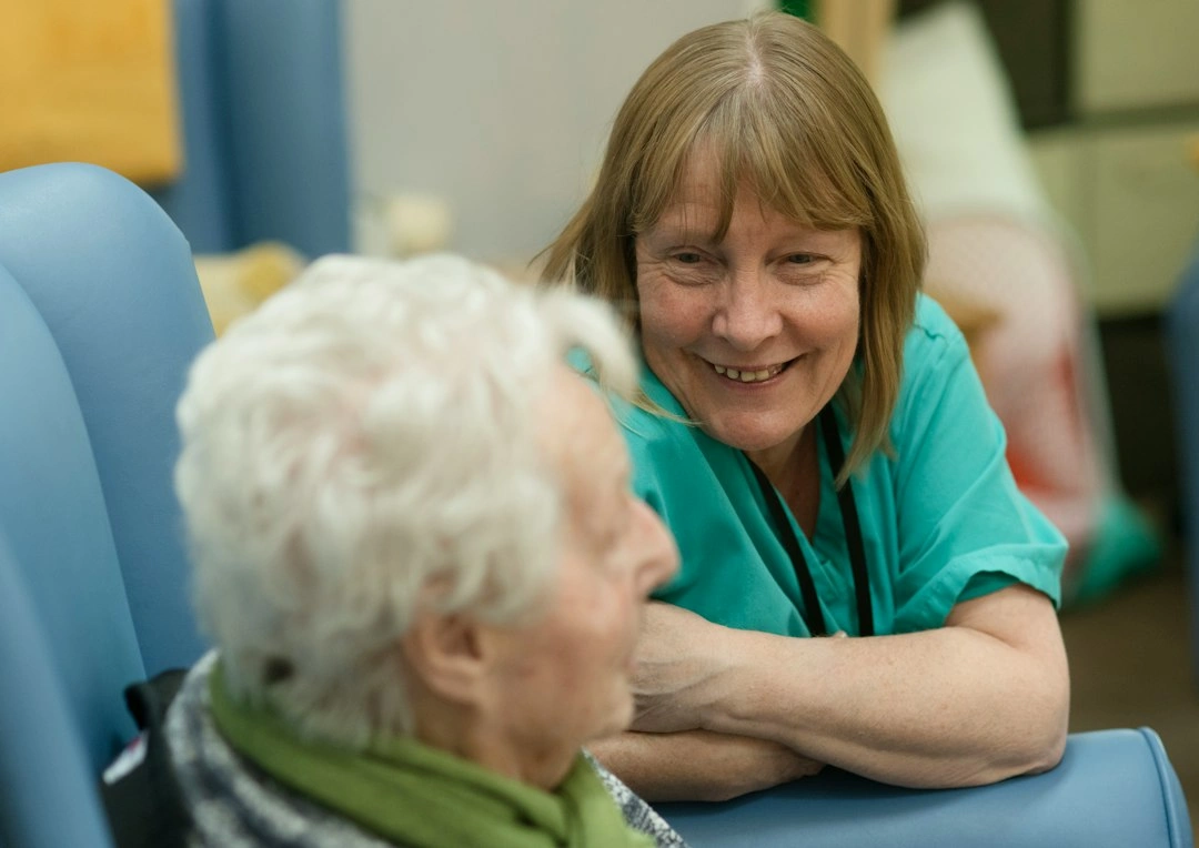 Nurse caring for an older woman at home