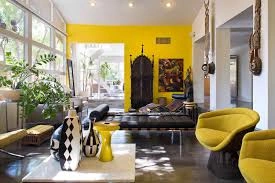 yellow contrasting wall in lounge area to match accent chairs.jfif