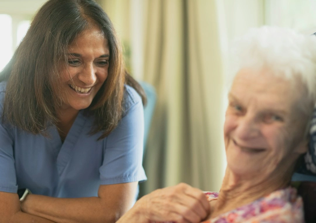 Support worker sharing a laugh with an older woman