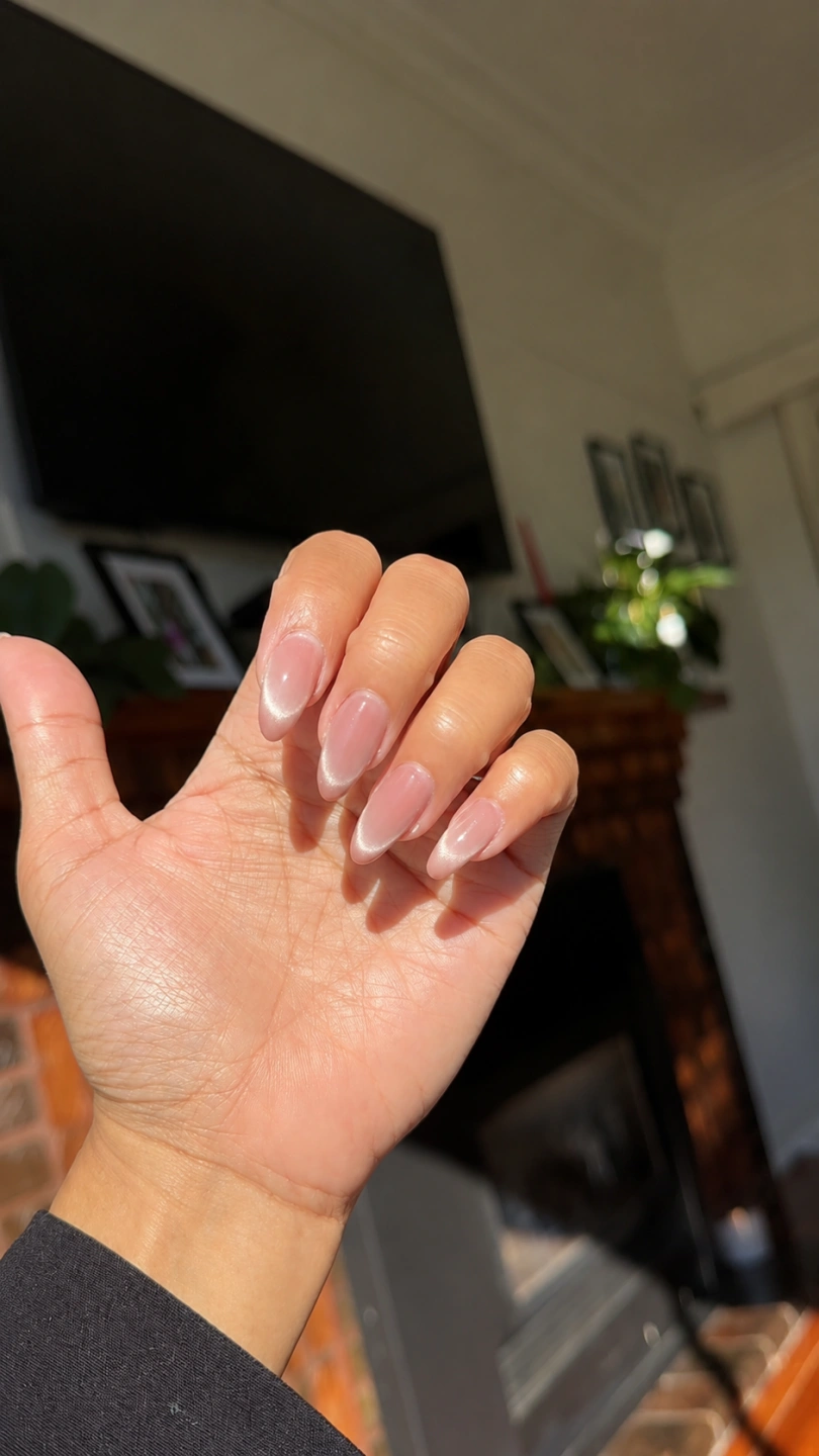 Close-up of glossy cat-eye nails on hand