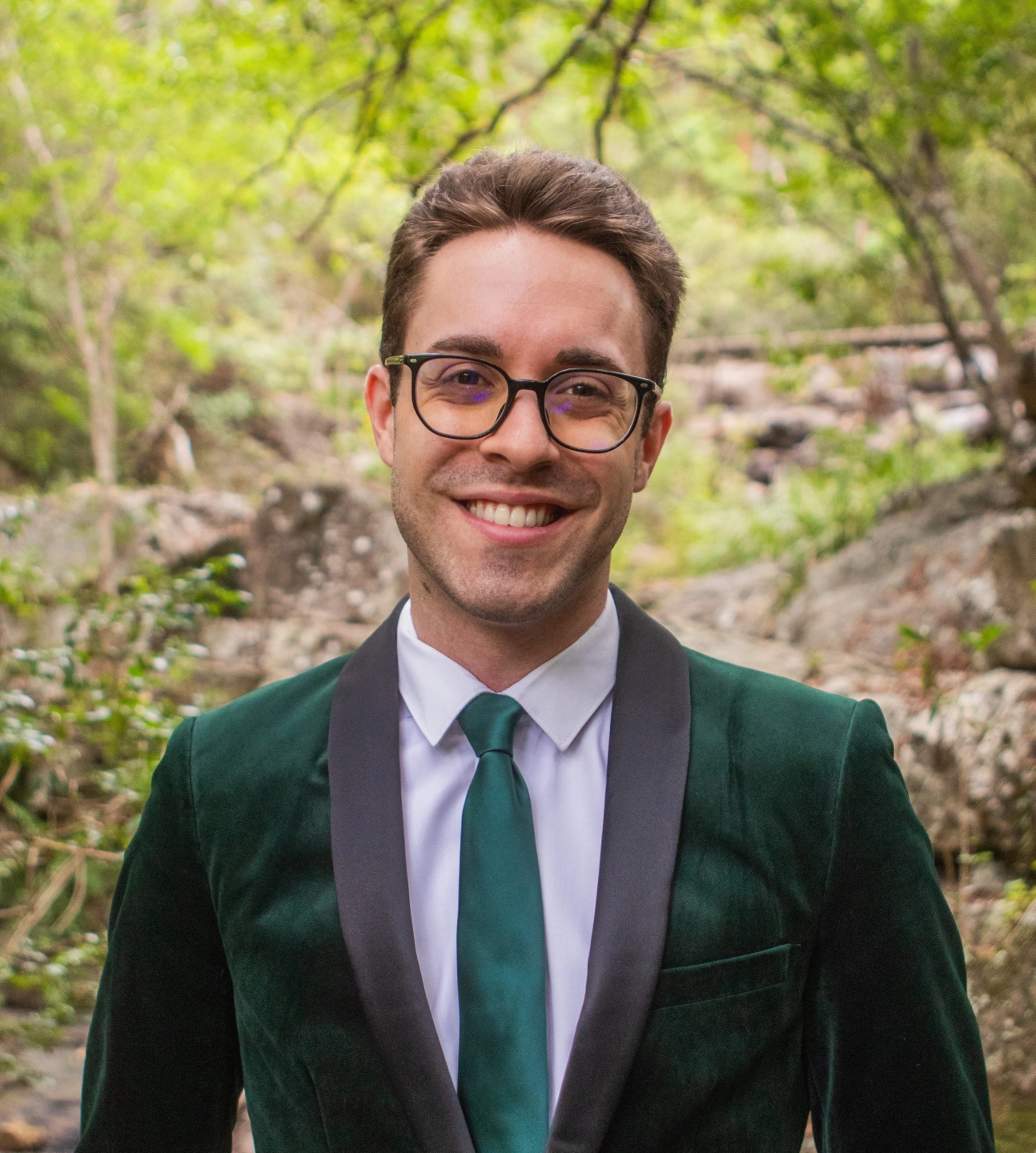 young-male-celebrant-grinning-in-green-suit.jpeg