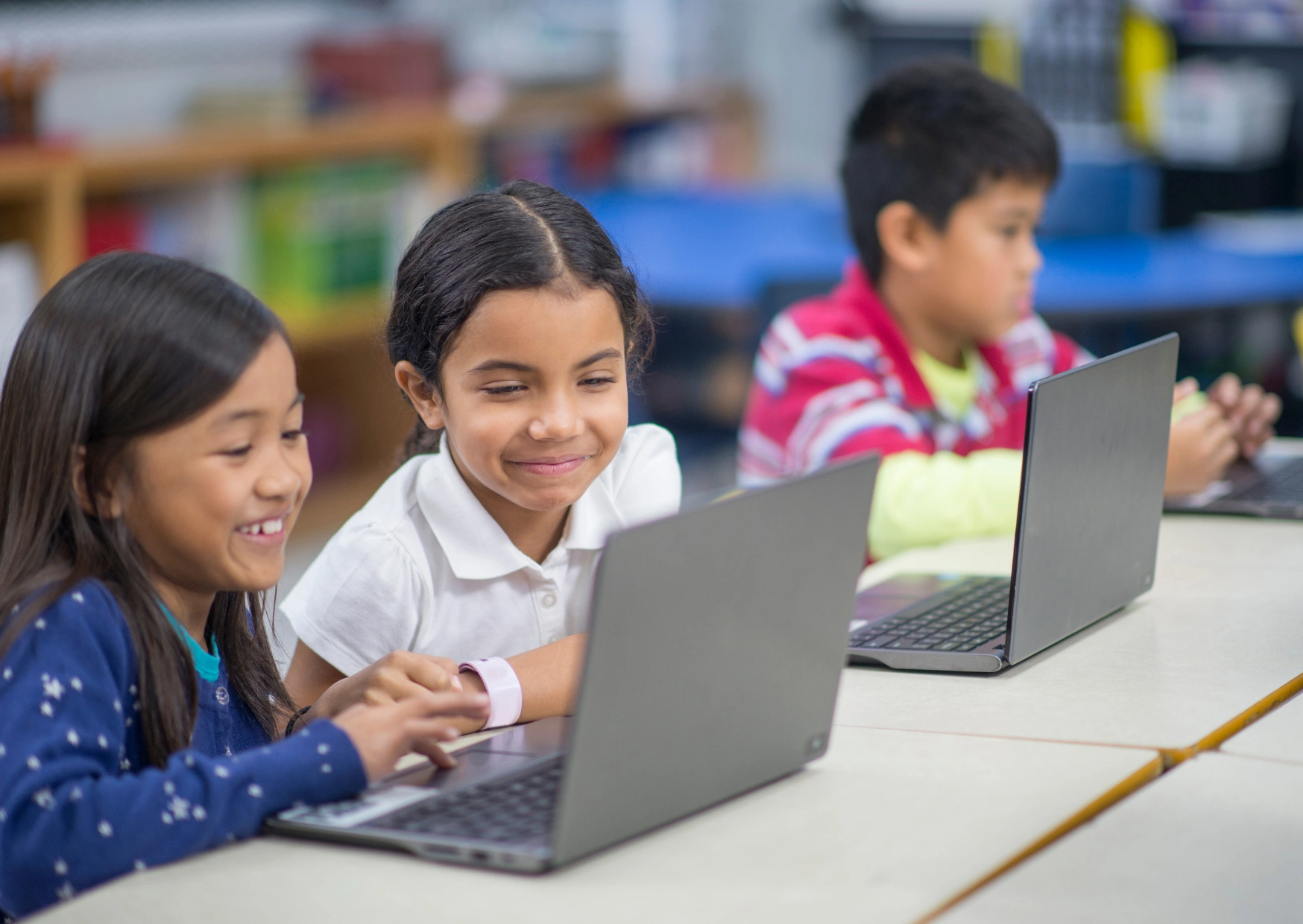 school kids working on laptops.png