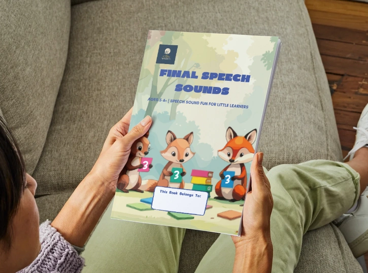 Workbook 3 held in hands on couch.png