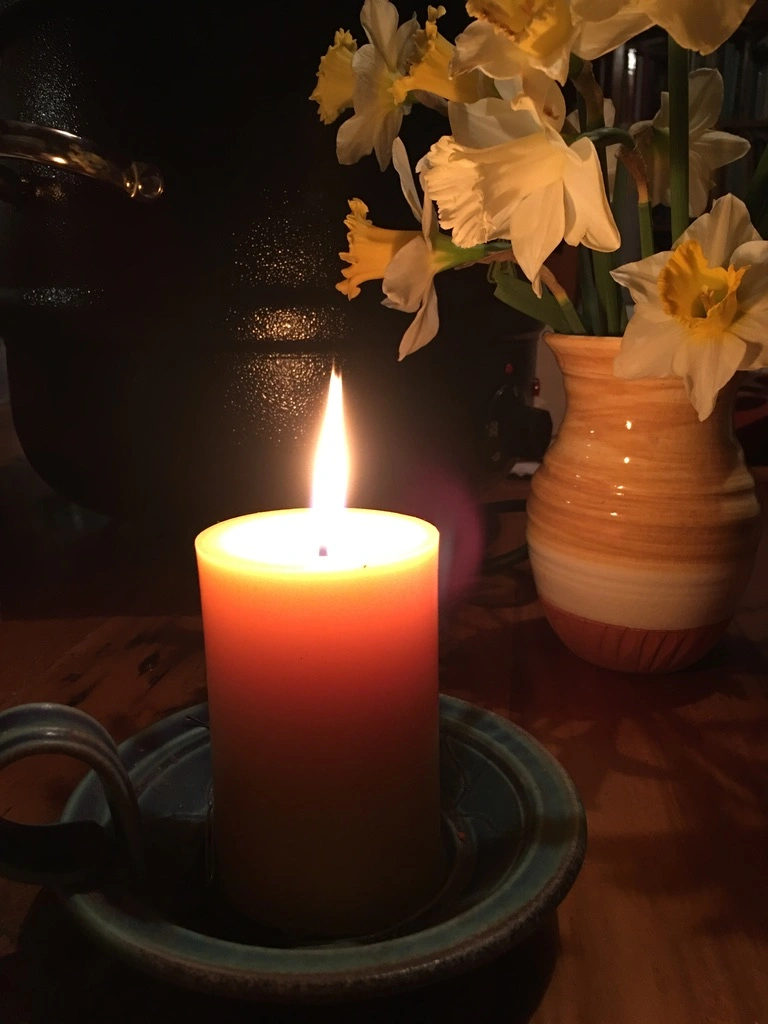 Candle with daffodils.jpeg