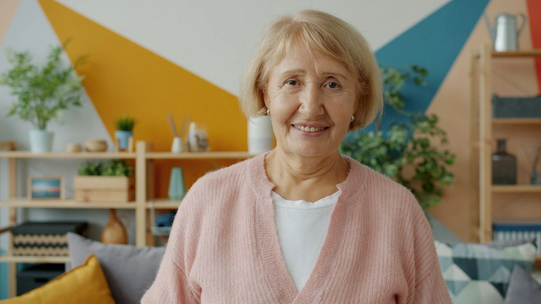 Older woman smiling in her tidy living room