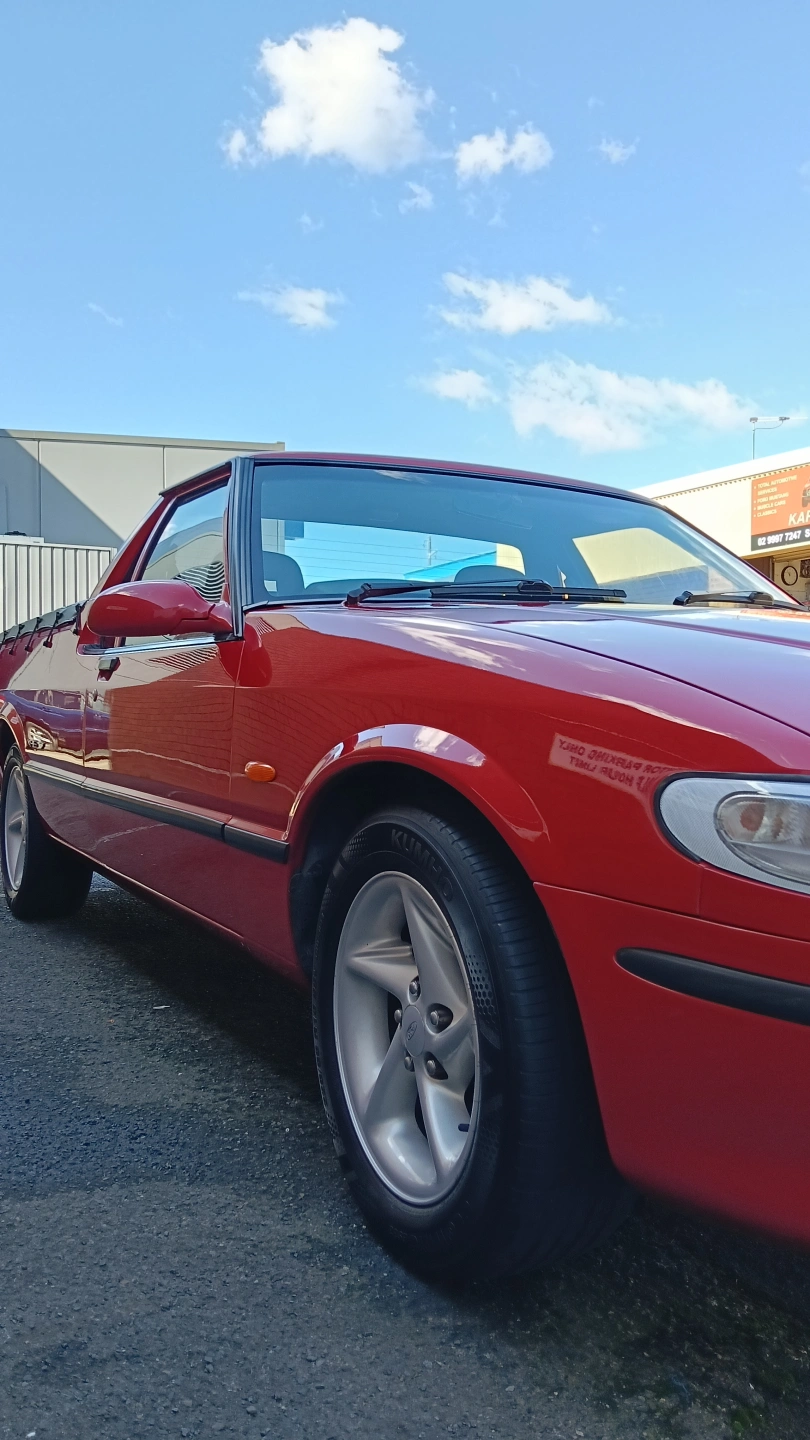 Glossy red car paintwork after paint correction and polishing by Paint By Popz, Sydney